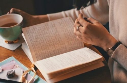 person journaling in cafe